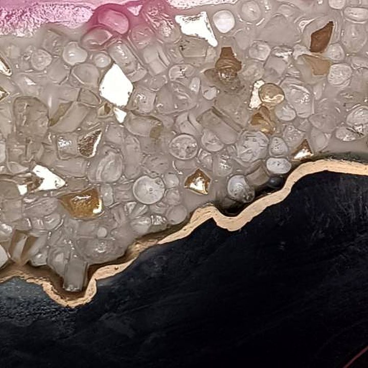 Close-up of glass crystals, gold lining and glossy black resin in Black Magic