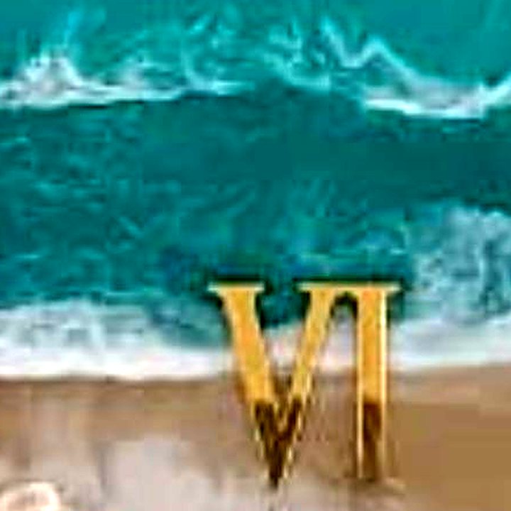 Close-up of the shoreline pour and gold numerals on the ocean wall clock