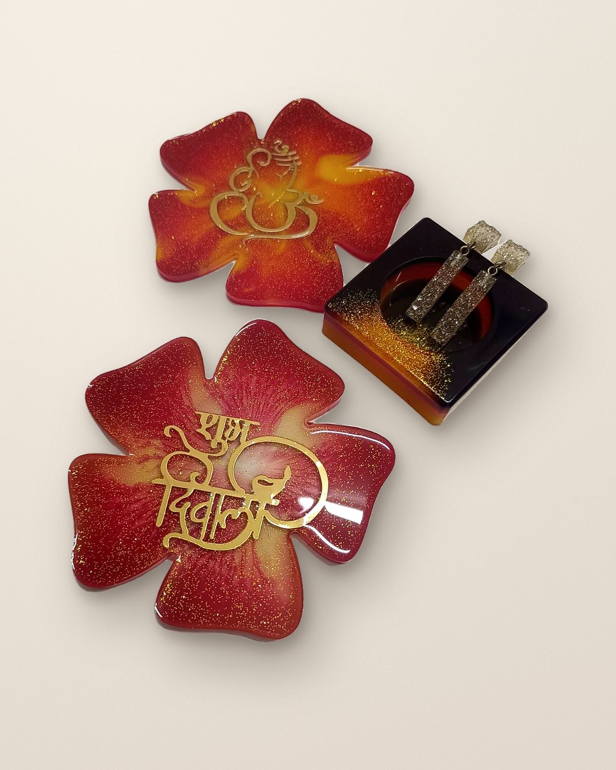 Red and gold Diwali resin flower platters with a square holder